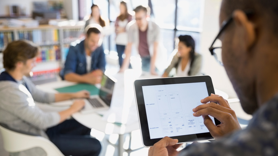 Businessman using digital tablet in meeting