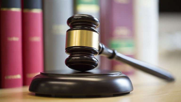 Gavel on table with legal books in the background