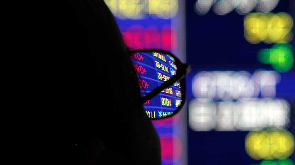 A man looks at a stock index board outside a brokerage in Tokyo August 25, 2010.